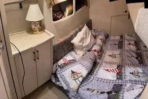 Slide: The Image of 1997 Bayliner 3788 Command Bridge Motoryacht cabin with cozy bed and nautical decor. - 21