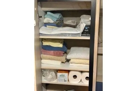 Slide: The Image of Storage cabinet on 1997 Bayliner 3788 yacht with towels and supplies. - 23