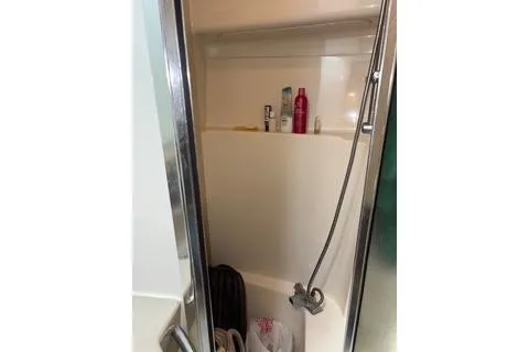 Slide: The Image of Shower area in 1997 Bayliner 3788 Command Bridge Motoryacht with toiletries and handheld showerhead. - 25
