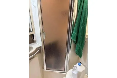 Slide: The Image of Bathroom interior of 1997 Bayliner 3788 Command Bridge Motoryacht with shower and green towel. - 27