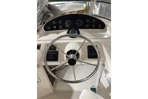 Slide: The Image of 1997 Bayliner 3788 Command Bridge Motoryacht helm with steering wheel and instrument panel. - 30