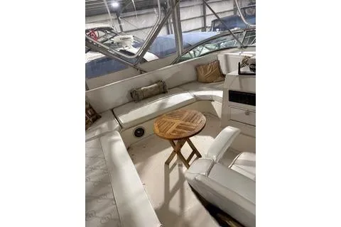 Slide: The Image of 1997 Bayliner 3788 Command Bridge Motoryacht interior with seating and wooden table. - 35