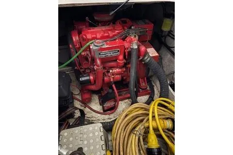 Slide: The Image of Engine compartment of a 1997 Bayliner 3788 Command Bridge Motoryacht with red machinery and cables. - 36