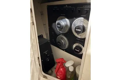 Slide: The Image of Electrical panel of 1997 Bayliner 3788 Command Bridge Motoryacht with cleaning supplies. - 38