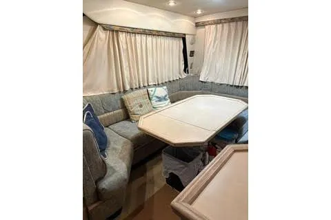 Slide: The Image of 1997 Bayliner 3788 Command Bridge Motoryacht interior kitchen with modern appliances and large windows. - 5