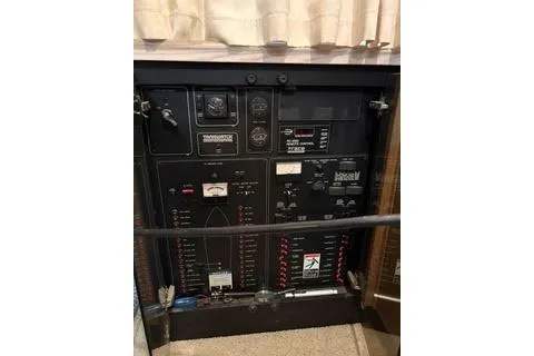 Slide: The Image of 1997 Bayliner 3788 Command Bridge Motoryacht kitchen with sink, cabinets, and nautical-themed rug. - 6