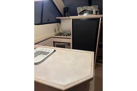 Slide: The Image of 1997 Bayliner 3788 Command Bridge Motoryacht kitchen with black fridge and microwave. - 7
