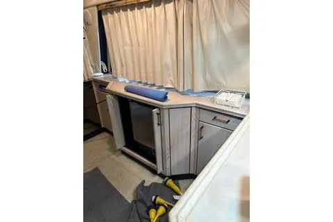 Slide: The Image of 1997 Bayliner 3788 Command Bridge Motoryacht kitchen with microwave and stove. - 8