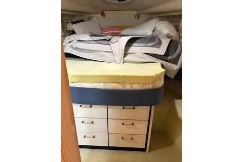 Slide: The Image of 1997 Bayliner 3788 Command Bridge Motoryacht kitchen with wooden cabinets and nautical-themed rug. - 9