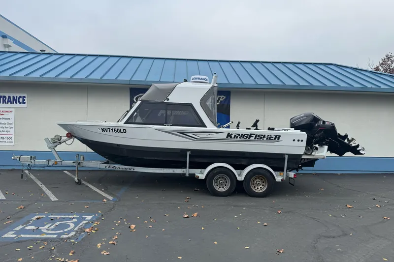 The Image of KingFisher 2025 Escape HHT boat on trailer, parked outside building, 2021 model. - 0