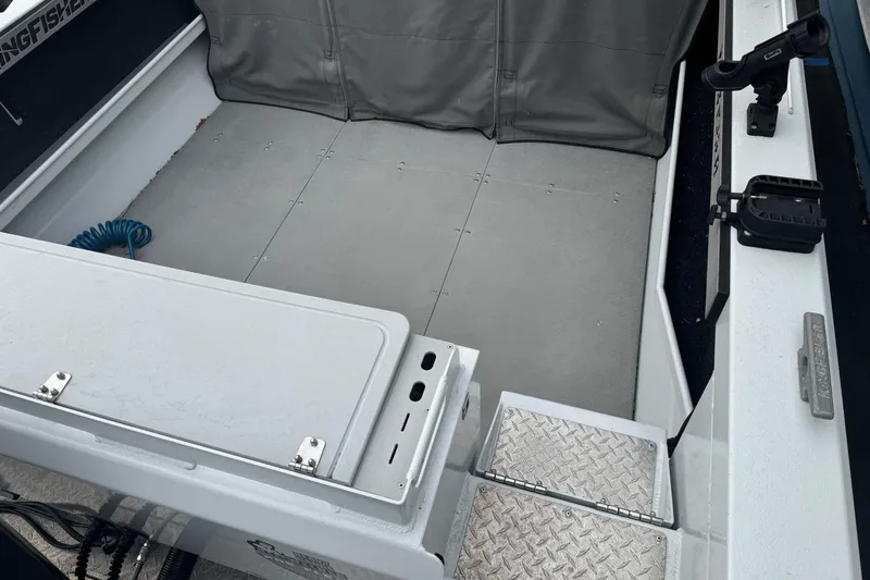 Slide: The Image of Interior view of a 2021 KingFisher 2025 Escape HHT boat, featuring a spacious deck. - 11