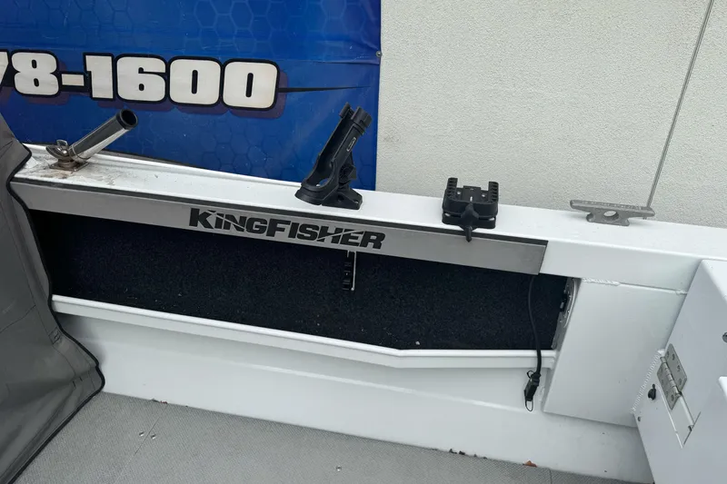 Slide: The Image of KingFisher 2025 Escape HHT boat interior with rod holders and storage compartment. - 16