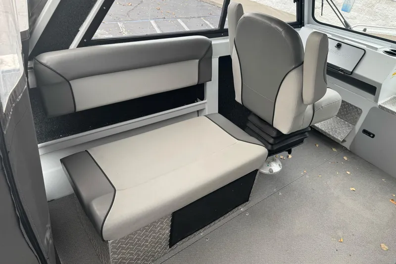 Slide: The Image of Interior of 2021 KingFisher 2025 Escape HHT boat with gray seating and modern design. - 19
