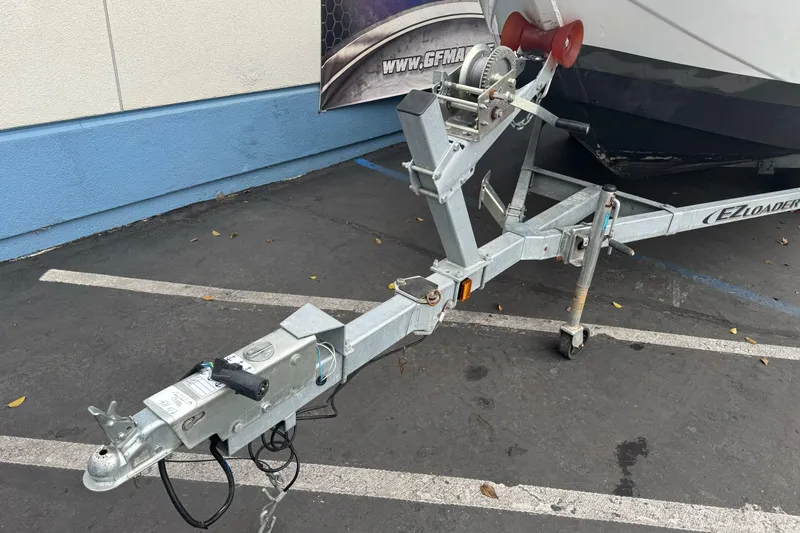 Slide: The Image of Trailer hitch of KingFisher 2025 Escape HHT boat, parked on asphalt. - 4
