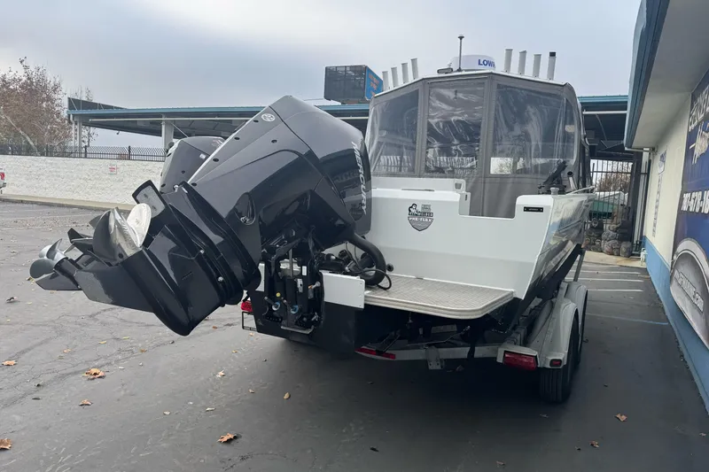 Slide: The Image of KingFisher 2025 Escape HHT boat, 2021 model, with powerful outboard motor on trailer. - 8