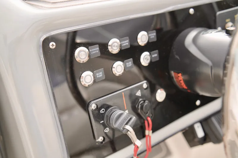 Slide: The Image of Control panel of a 2006 Bayliner 285 boat with switches and ignition. - 11