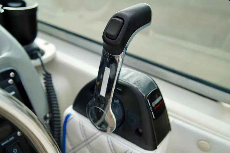 Slide: The Image of Throttle control lever on a 2006 Bayliner 285 boat dashboard. - 13