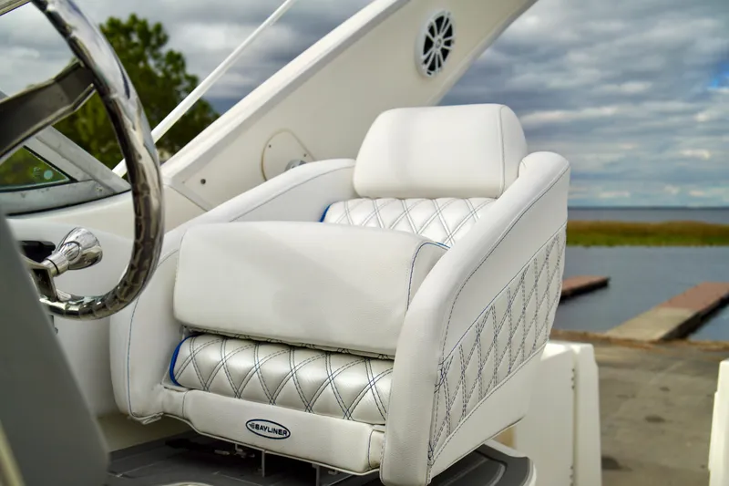 Slide: The Image of Luxurious white seating on a 2006 Bayliner 285 boat, dockside view. - 14