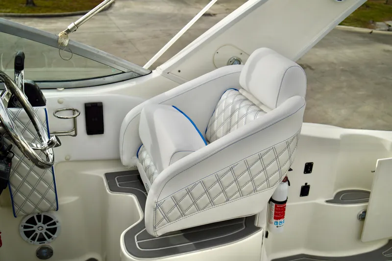 Slide: The Image of Captain's seat on 2006 Bayliner 285 boat, featuring quilted upholstery and steering wheel. - 15