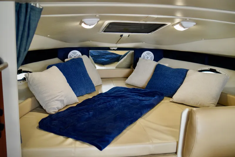 Slide: The Image of Interior cabin of a 2006 Bayliner 285 boat with cozy bedding and cushions. - 17
