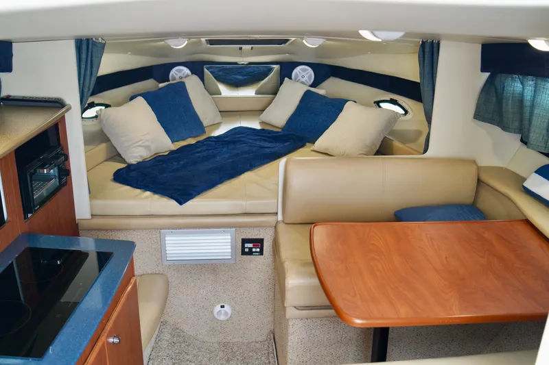 Slide: The Image of Interior of 2006 Bayliner 285 boat with cozy seating and sleeping area. - 18