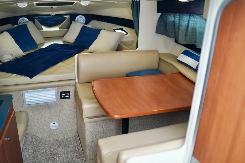 Slide: The Image of Interior of 2006 Bayliner 285 boat with cozy seating and sleeping area. - 19