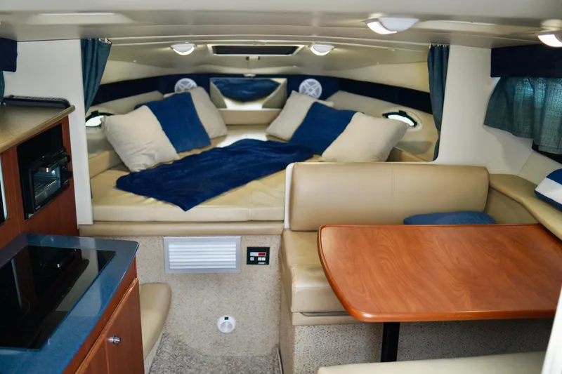 Slide: The Image of Interior of 2006 Bayliner 285 boat with cozy seating and dining area. - 20