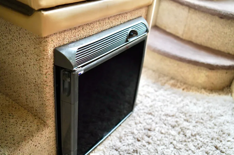 Slide: The Image of 2006 Bayliner 285 interior with compact refrigerator and carpeted stairs. - 24