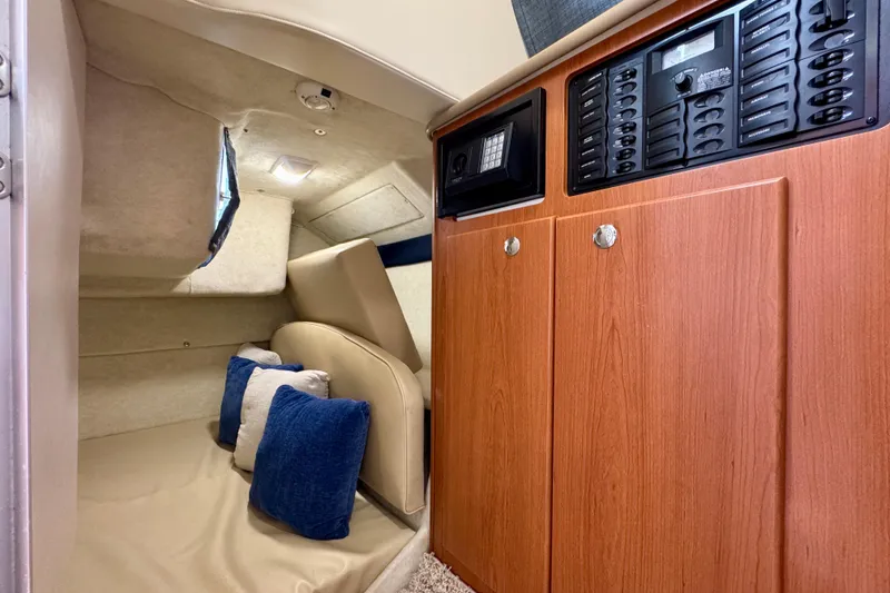 Slide: The Image of Interior cabin of 2006 Bayliner 285 boat with cozy seating and control panel. - 28