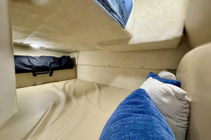 Slide: The Image of 2006 Bayliner 285 cabin interior with cozy bedding and soft lighting. - 29