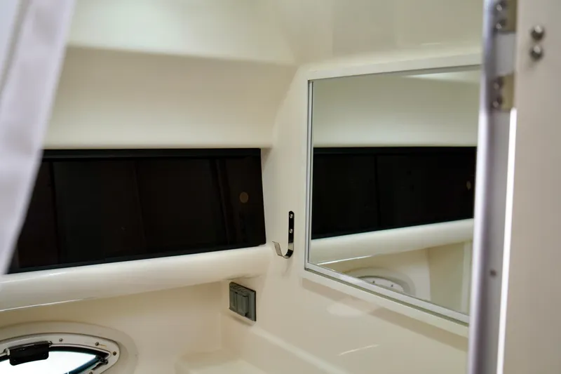 Slide: The Image of Interior of 2006 Bayliner 285 boat showing mirror and window details. - 32