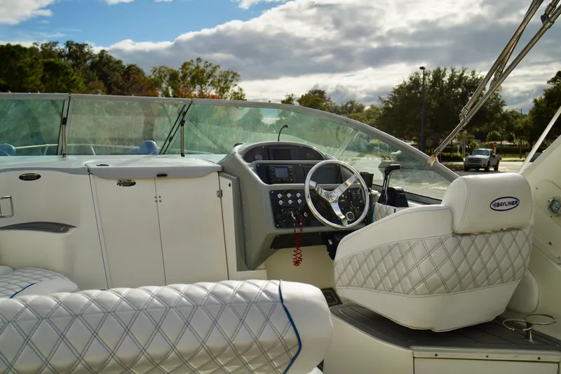 Slide: The Image of 2006 Bayliner 285 boat interior with steering wheel and quilted seating. - 35
