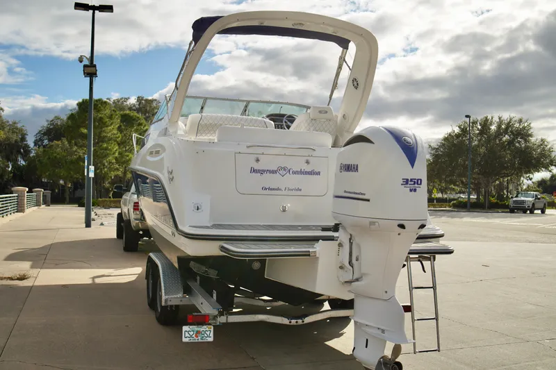 Slide: The Image of 2006 Bayliner 285 boat with Yamaha 350 V8 engine on trailer, parked outdoors. - 43