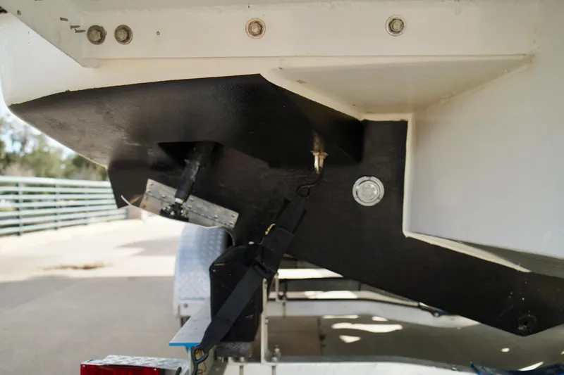 Slide: The Image of 2006 Bayliner 285 boat hull and trailer detail, showing underside and attachment points. - 45