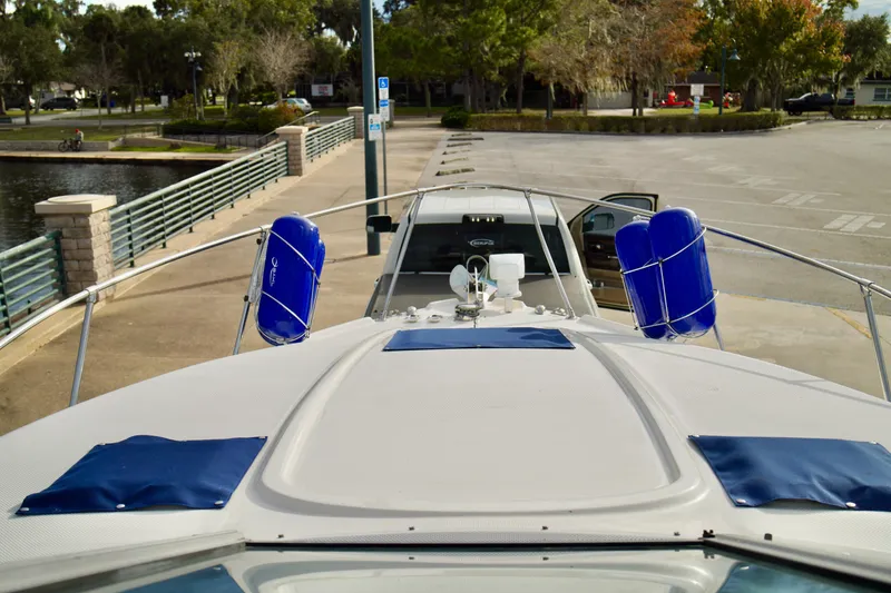 Slide: The Image of 2006 Bayliner 285 boat docked at a marina with blue fenders. - 8