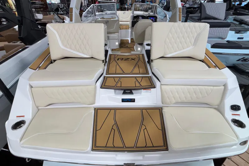 Slide: The Image of 2026 Tigé 22RZX boat interior with luxurious beige seating and stylish deck design. - 10