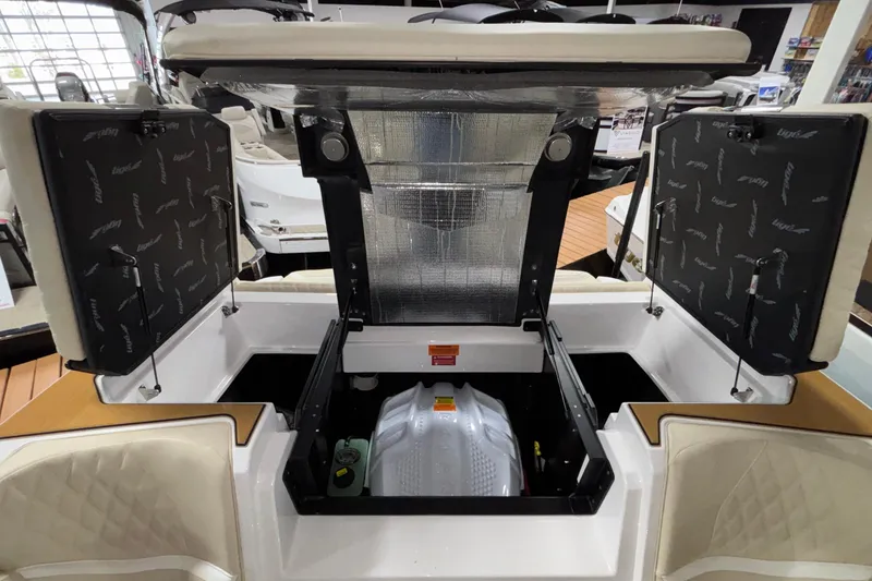 Slide: The Image of 2026 Tigé 22RZX boat engine compartment with open hatches, showcasing interior details. - 19