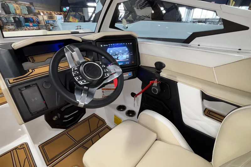 Slide: The Image of Interior of 2026 Tigé 22RZX boat featuring modern steering and touchscreen controls. - 30