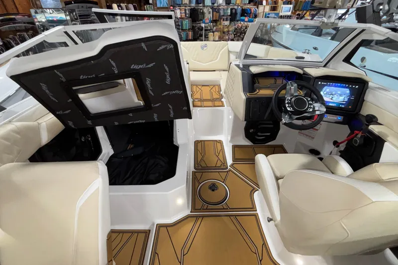 Slide: The Image of 2026 Tigé 22RZX boat interior with modern dashboard, touchscreen, and beige seating. - 37