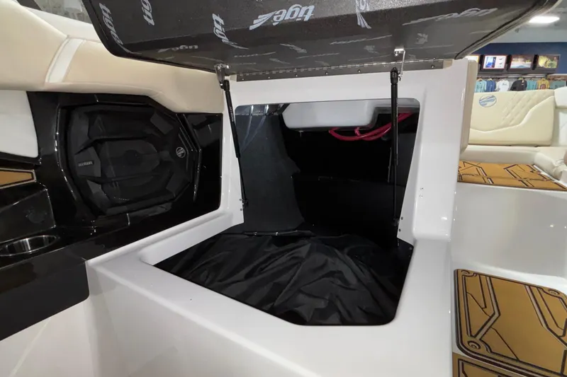 Slide: The Image of 2026 Tigé 22RZX boat interior storage compartment with open hatch and speaker system. - 38