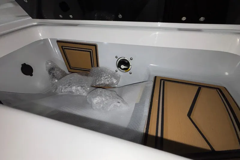 Slide: The Image of Interior storage compartment of 2026 Tigé 22RZX boat with bubble wrap and padding. - 40