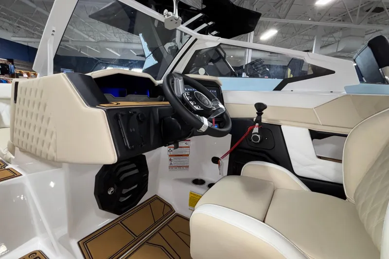 Slide: The Image of 2026 Tigé 22RZX boat interior with modern dashboard and beige seating. - 44