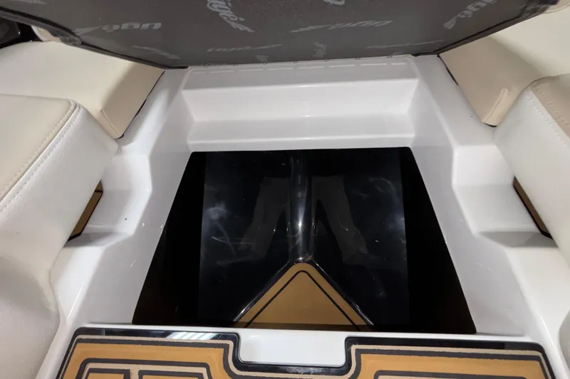 Slide: The Image of Interior view of 2026 Tigé 22RZX boat, featuring seating and storage area. - 49
