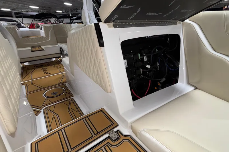 Slide: The Image of 2026 Tigé 22RZX boat interior with open storage compartment and luxurious seating. - 51