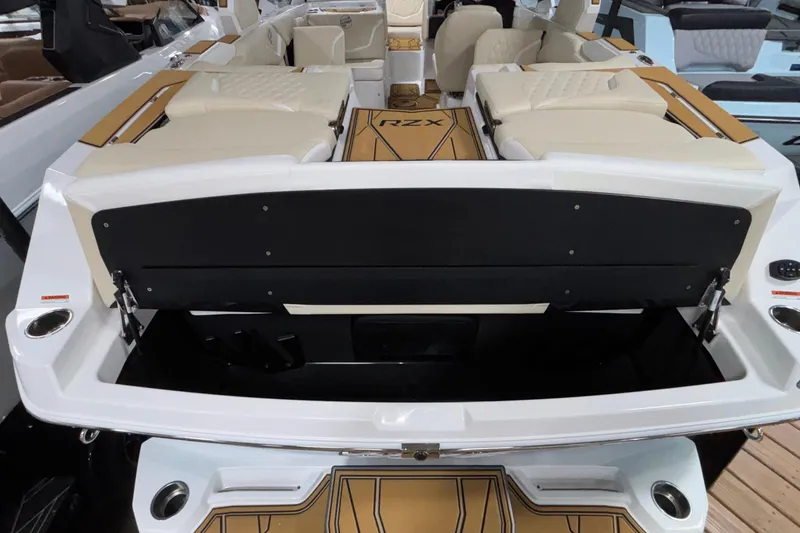 Slide: The Image of 2026 Tigé 22RZX boat interior with beige seating and open storage compartment. - 59