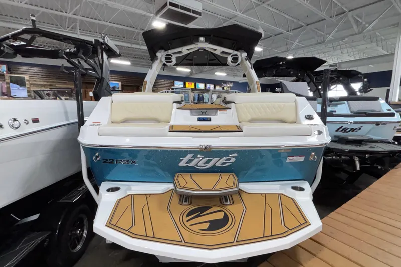 Slide: The Image of 2026 Tigé 22RZX boat with sleek design and spacious seating in showroom. - 8