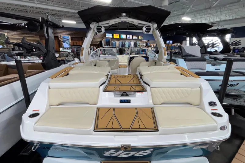 Slide: The Image of 2026 Tigé 22RZX boat interior with luxurious seating and modern design in showroom. - 9