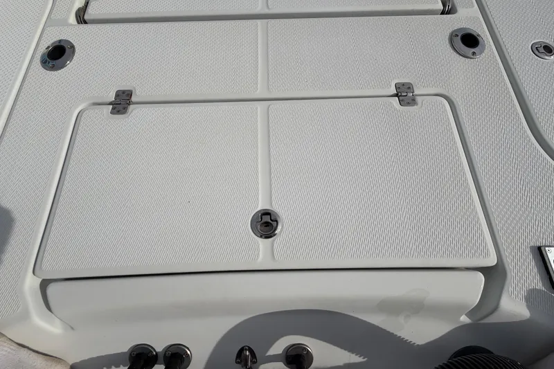 Slide: The Image of 2018 Blue Wave 2800 Pure Hybrid boat deck with textured surface and storage hatches. - 14