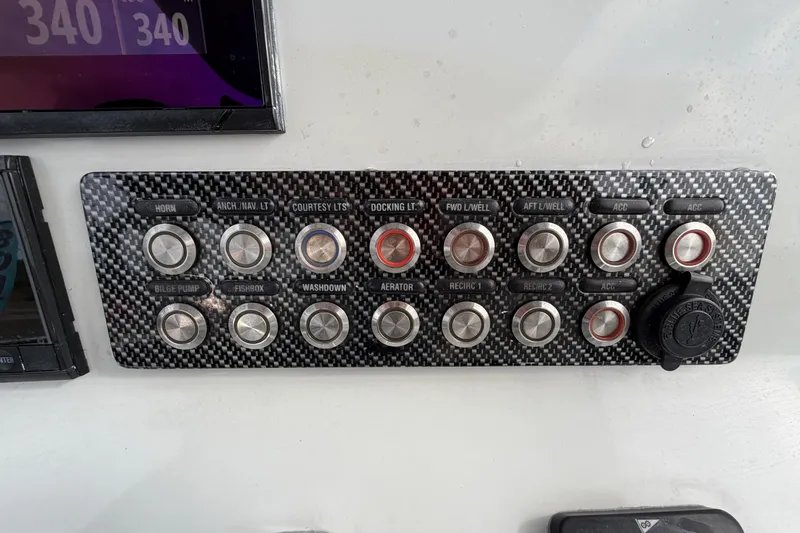 Slide: The Image of 2018 Blue Wave 2800 Pure Hybrid boat console with steering wheel and navigation display. - 28