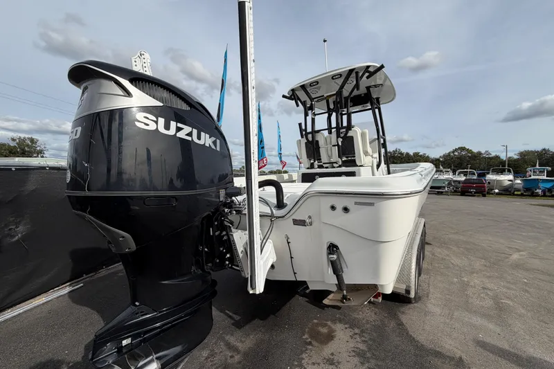 Slide: The Image of 2018 Blue Wave 2800 Pure Hybrid boat with Suzuki engine, parked outdoors. - 3